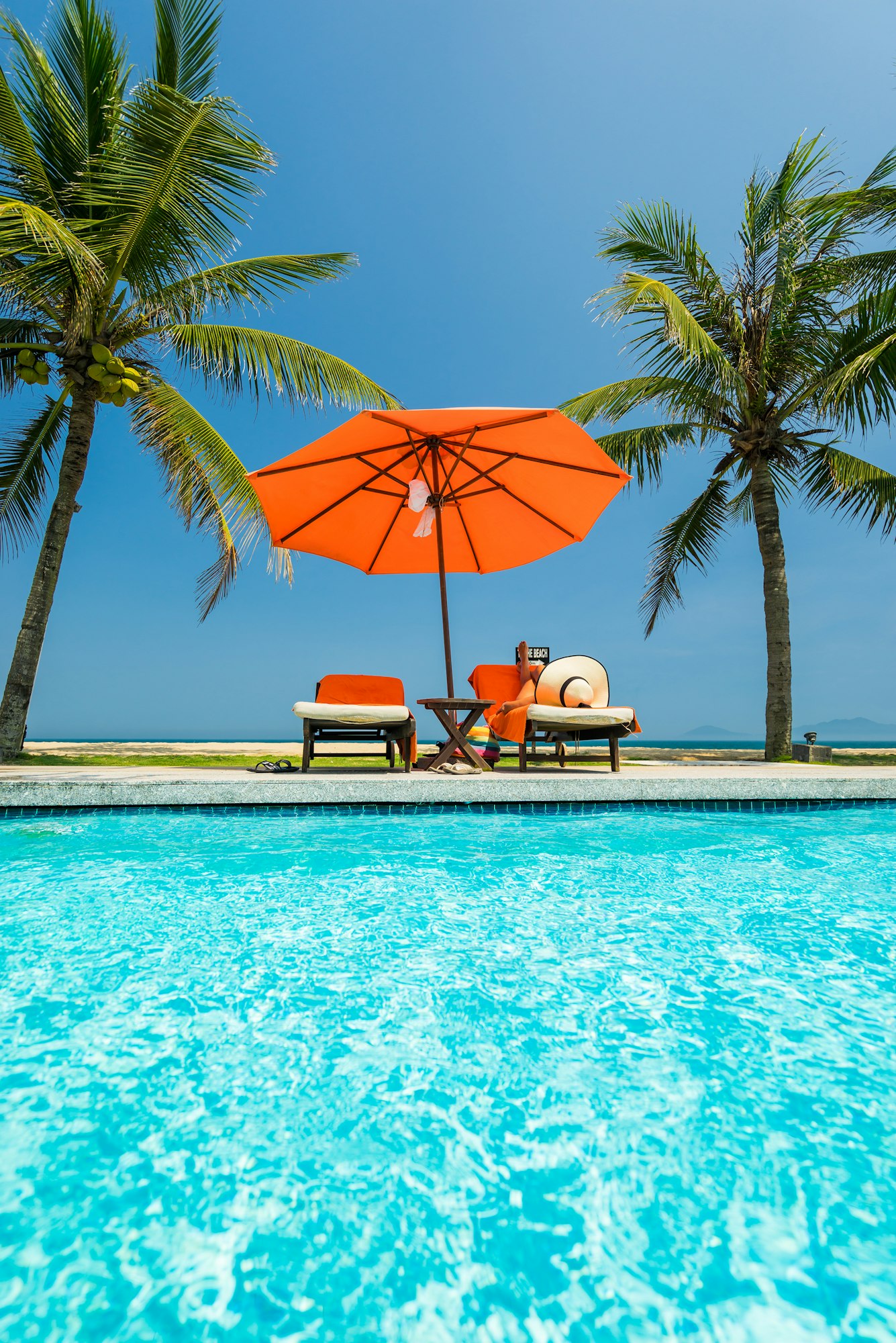 woman in luxury spa resort swimming pool.