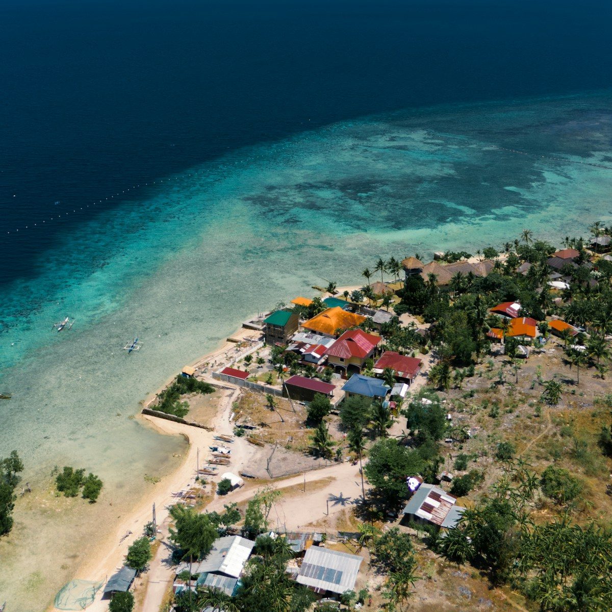 an aerial view of a small village by the ocean